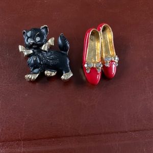 2 small ceramic and gold tone pins.